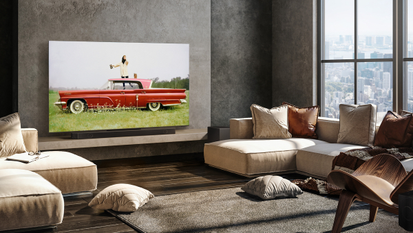 a model standing on a red 1959 continental mark iv hard-top sedan car, parked in a grassy field with white flowers. shot by john rawlings